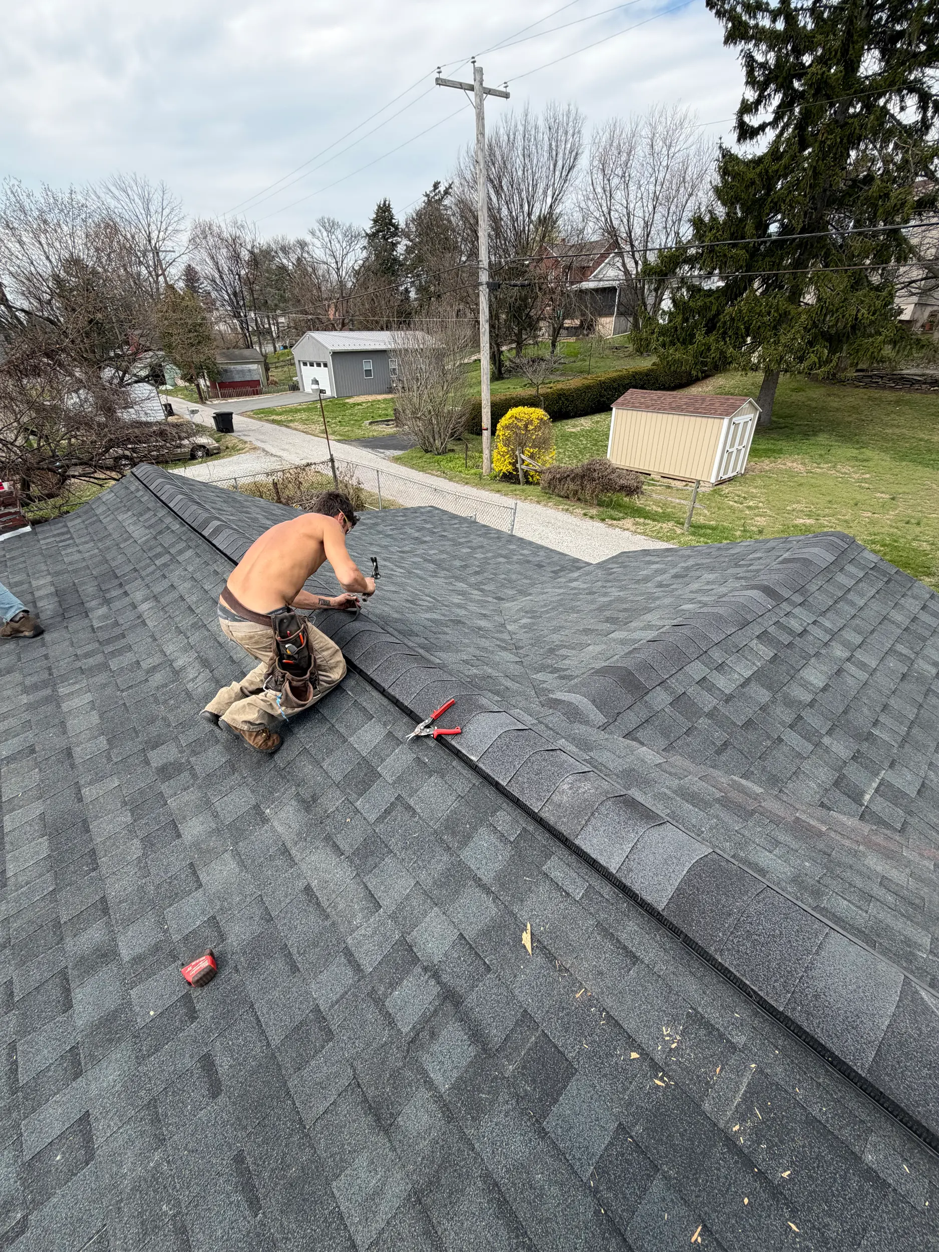 Quietstorm Exteriors craftsman hand-nailing architectural shingles