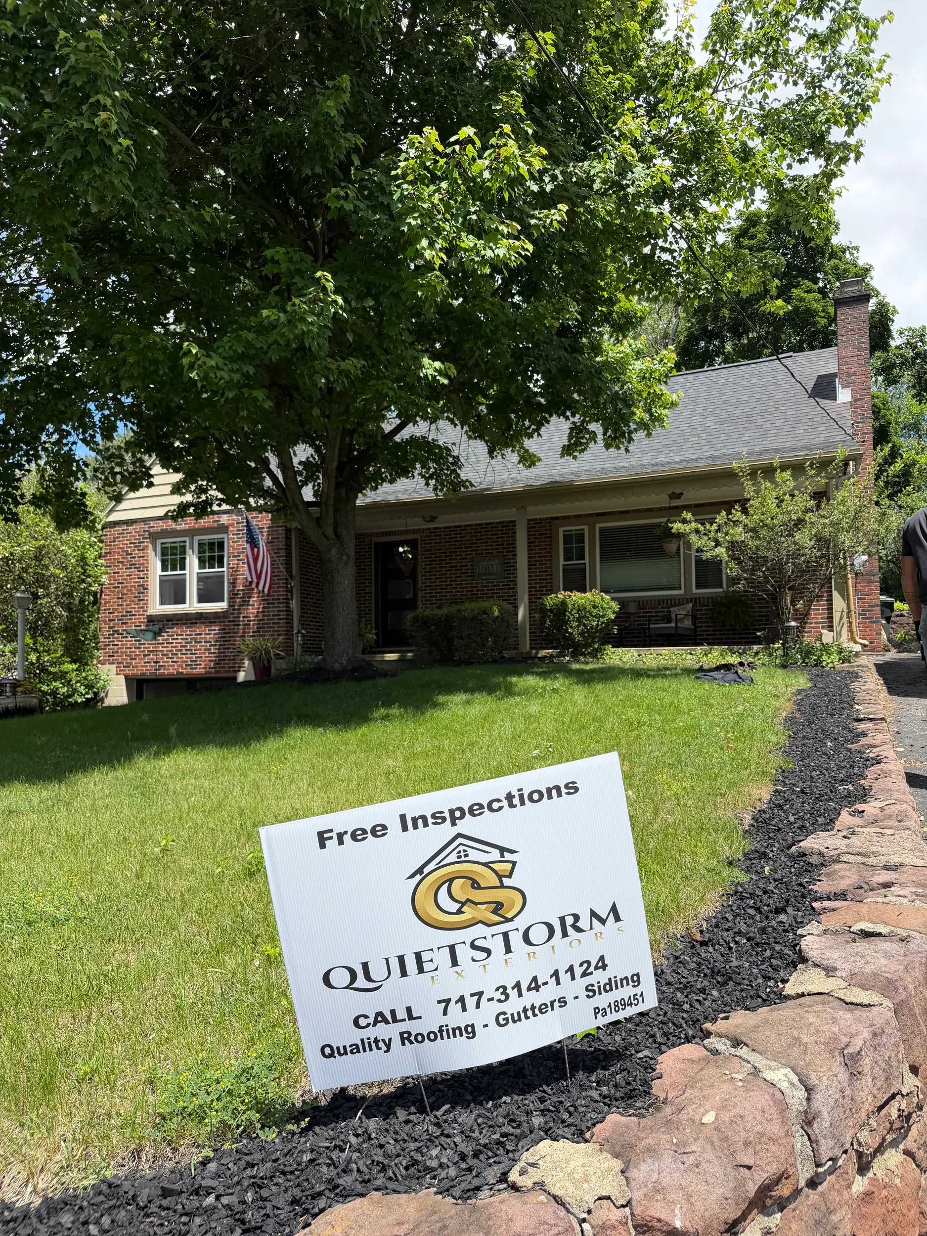 Quietstorm Exteriors yard sign in front of a freshly roofed home in a Lancaster, PA neighborhood